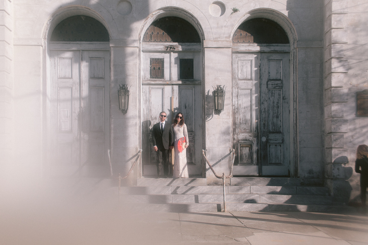 Couple stands in front of Marigny Opera House on their wedding day. Photo taken by New Orleans photographer Brei Olivier.